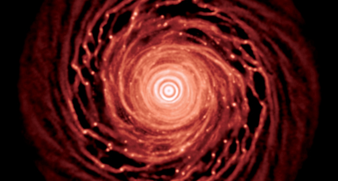 Illustration of a planetary system coalescing from disks of gas and dust orbiting a star.
