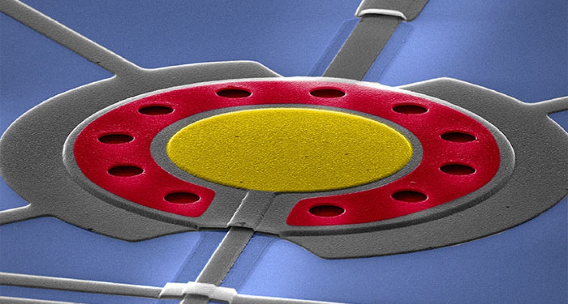 A false-colored scanning electron micrograph of a circuit.